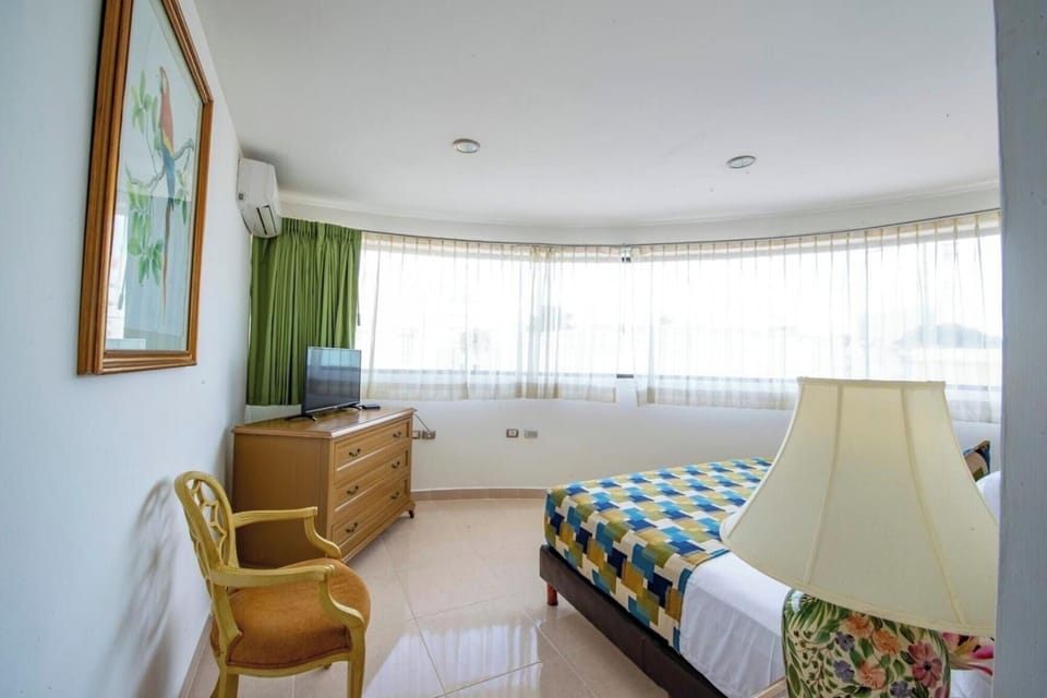 Soak in daylight beside wide windows and comfortable sleeping space.