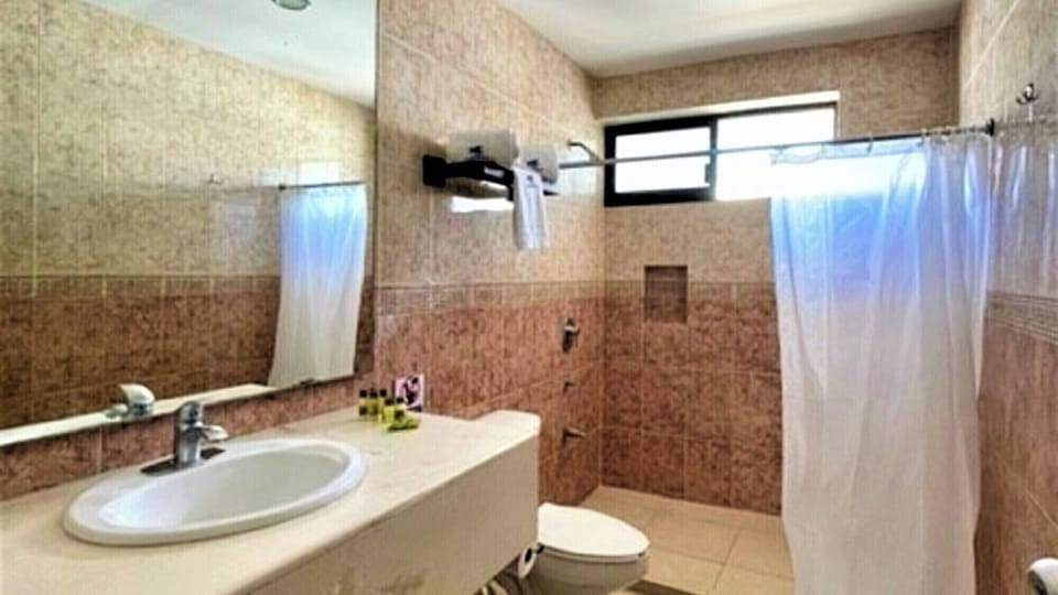Refresh in a spacious bathroom with wide vanity and shower.