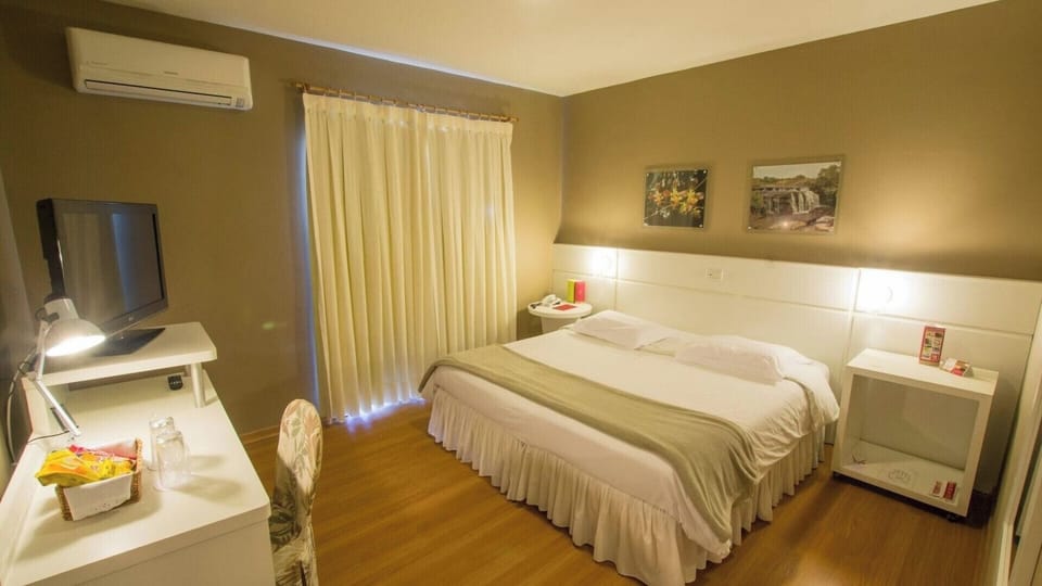 Settle into a spacious room with work desk and TV.