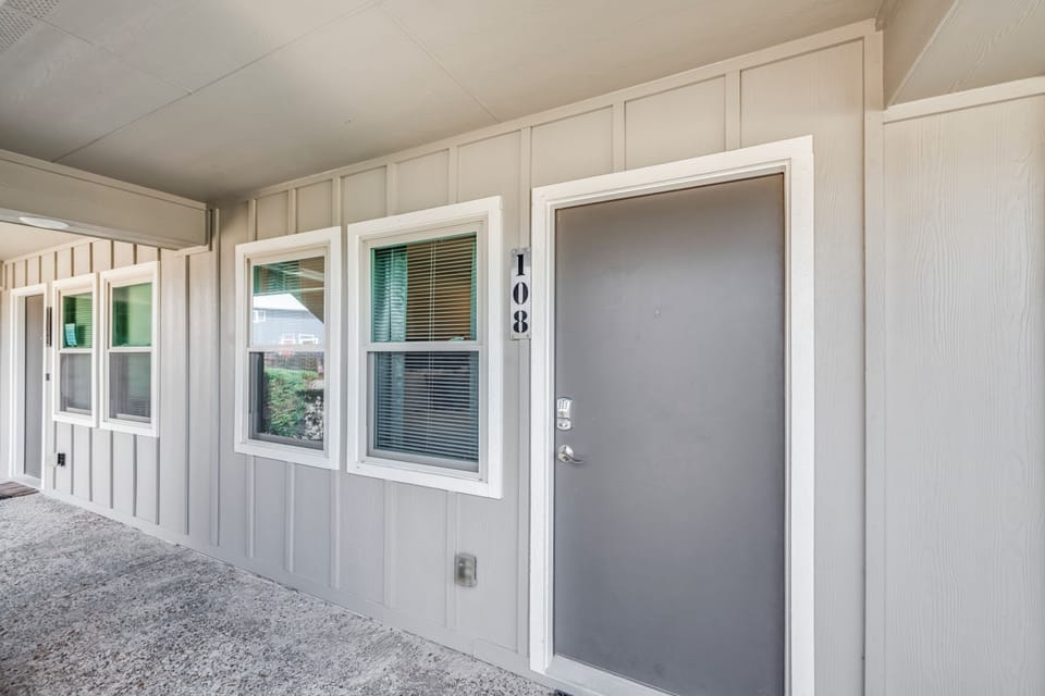 Exterior entrance to unit 108 with clean architectural lines and covered walkway for comfortable arrival.