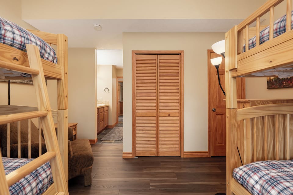 Sleep soundly in your cozy bunk bed retreat with warm wood furnishings and thoughtful storage throughout the space.