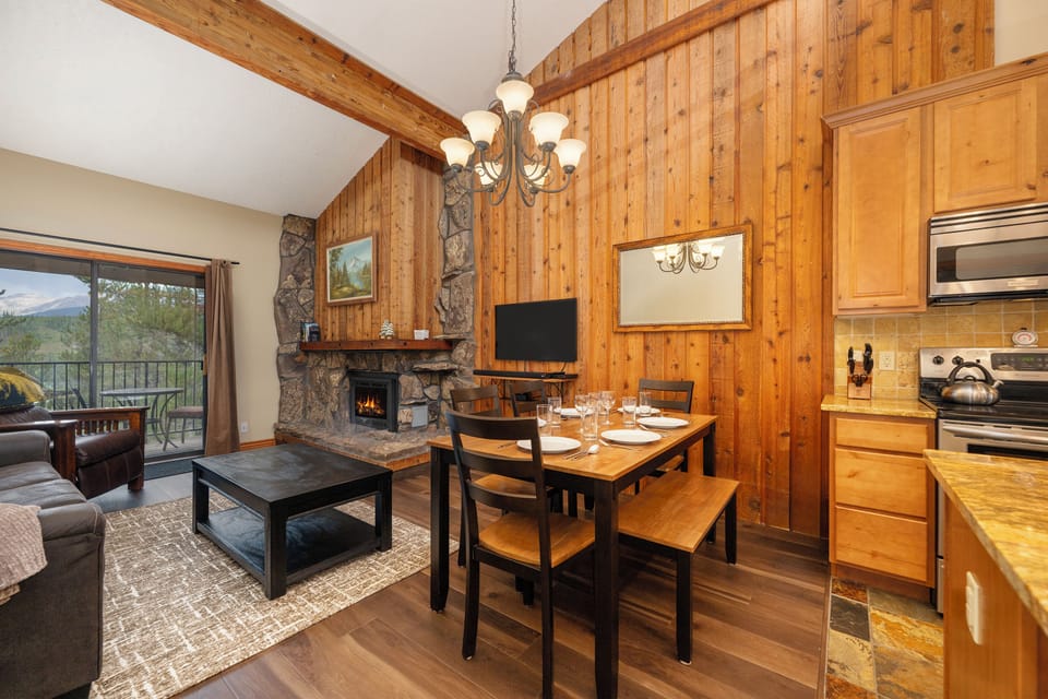 Cozy up by your crackling stone fireplace while enjoying mountain views from this warm, wood-paneled retreat with full kitchen.