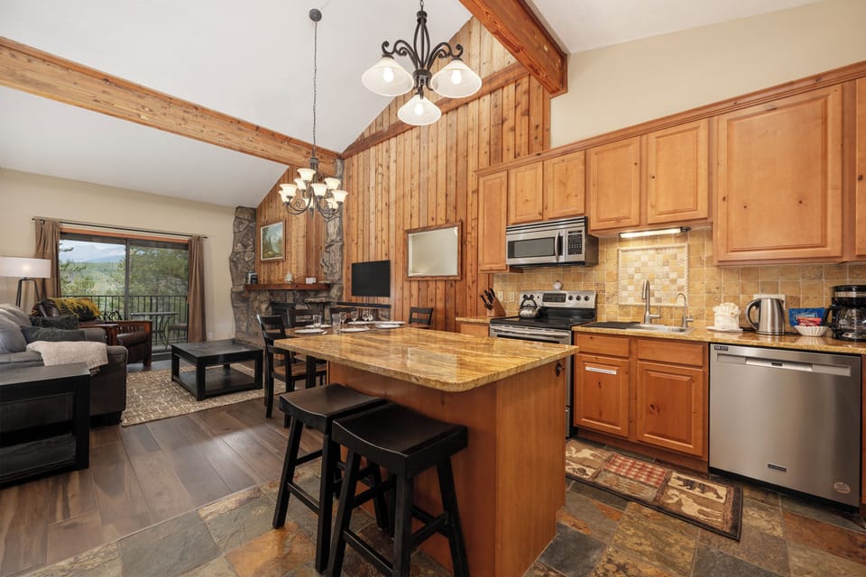 Your mountain retreat features a fully equipped kitchen with granite island, perfect for cooking together while enjoying scenic views.