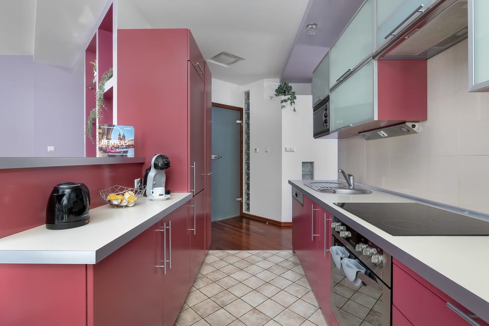 The sleek design of the kitchenette blending seamlessly with the living area.