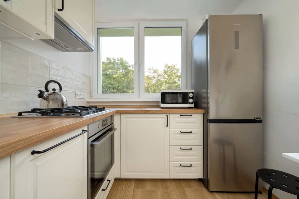 The sleek design of the kitchenette blending seamlessly with the living area.