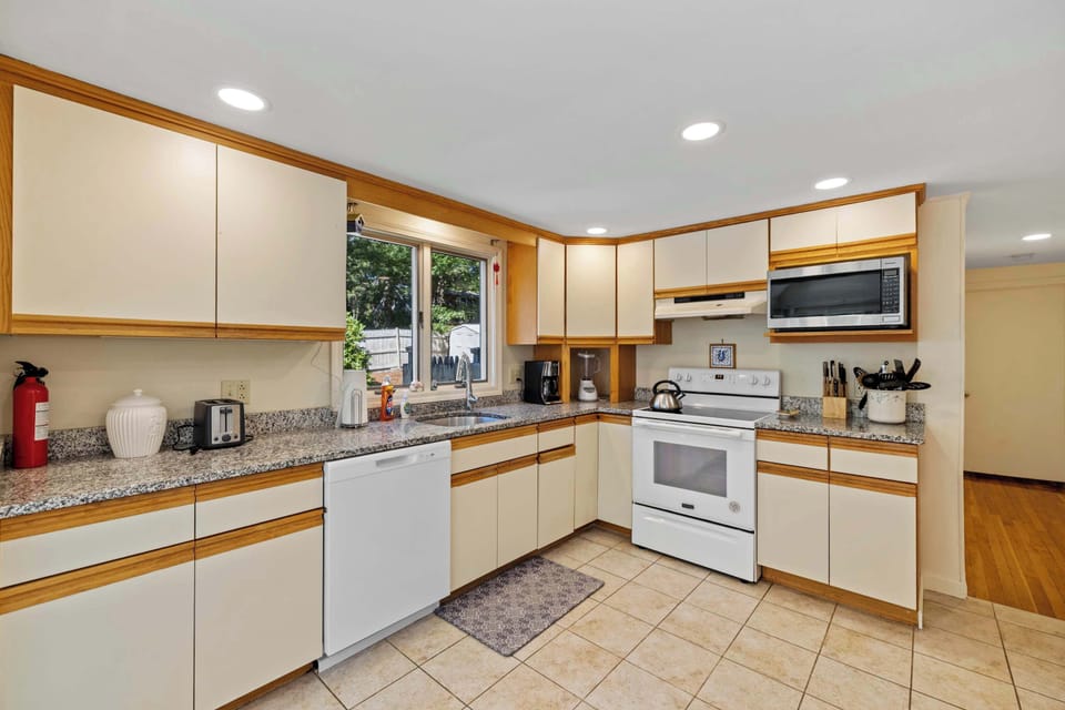 Bright kitchen with full-size fridge and microwave