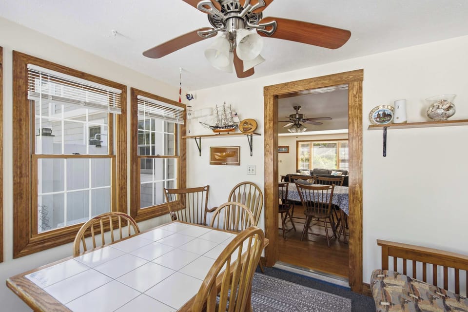 Sun porch dining nook with plenty of natural light and space for games or morning coffee.