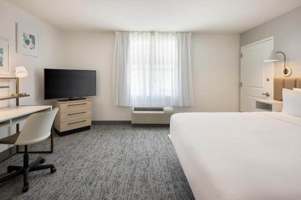 Settle in with roomy comfort, streaming-ready TV, and workspace.
