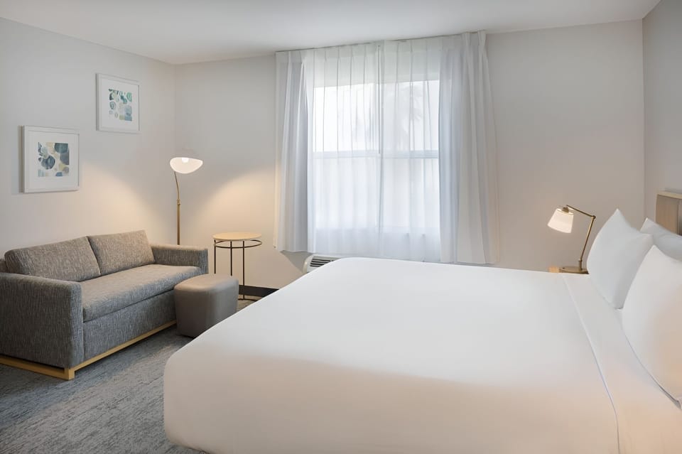 Stretch out with a cozy sofa corner beside the bed.