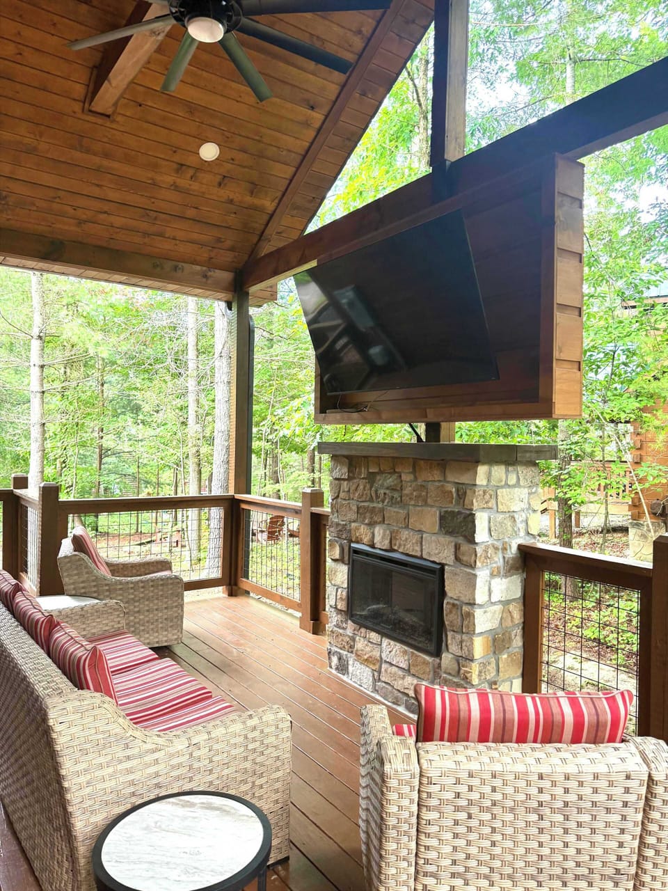 Cozy outdoor fireplace with dig screen TV