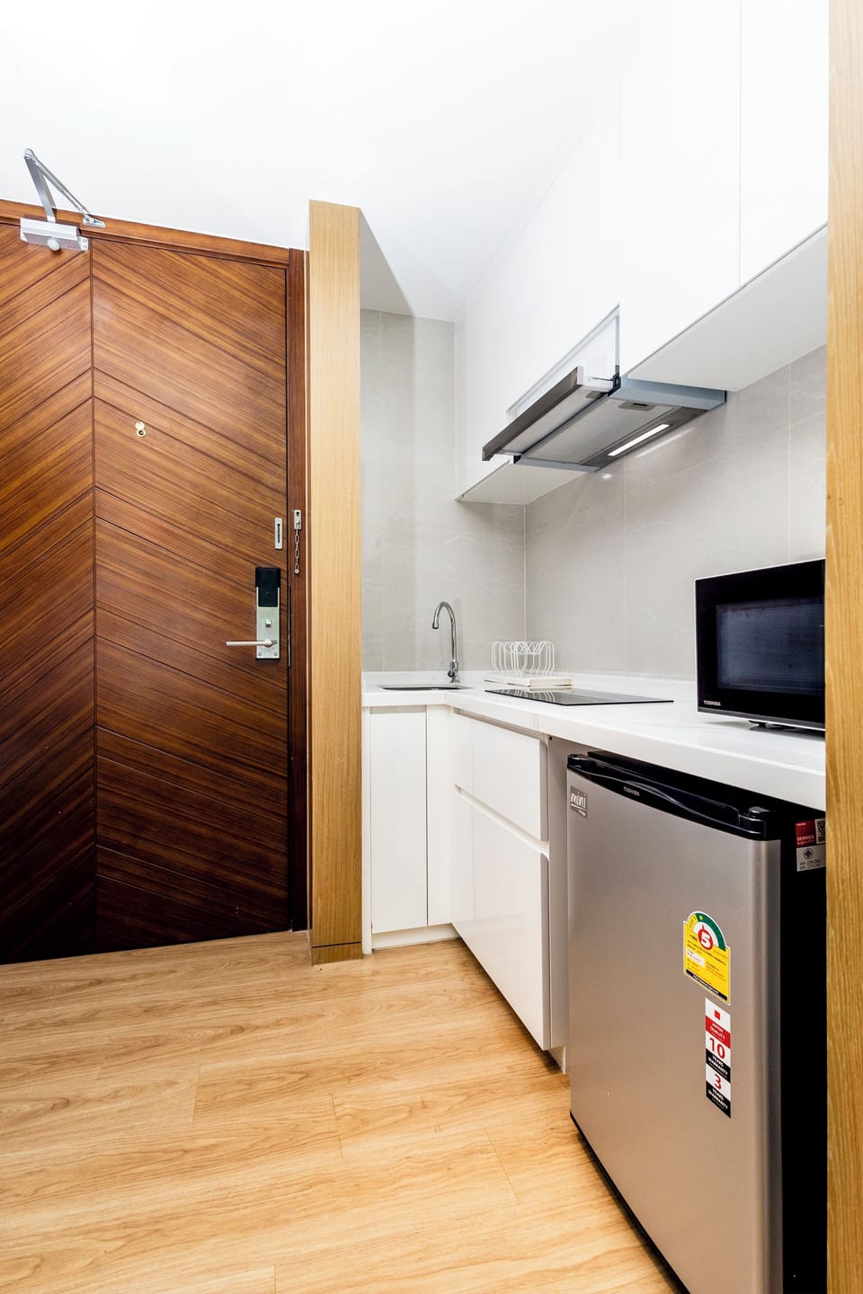 Fully equipped open kitchen with modern appliances.
