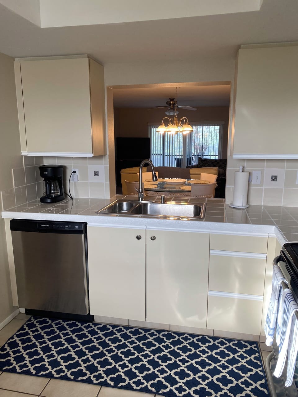 Fully stored kitchen opened to open floor plan, lanai and look at that view!