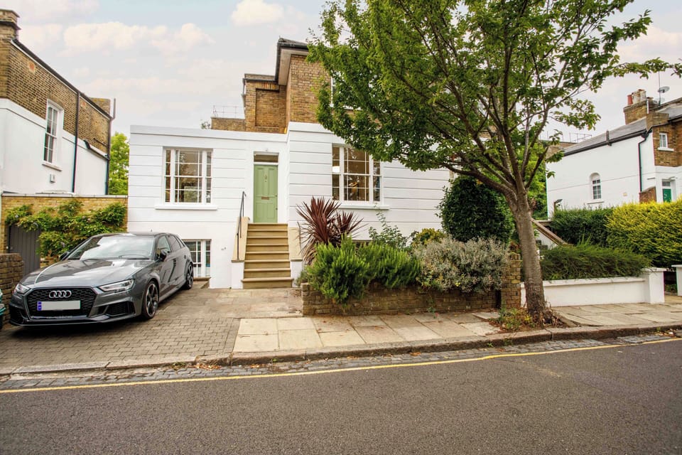 Front of house with parking space