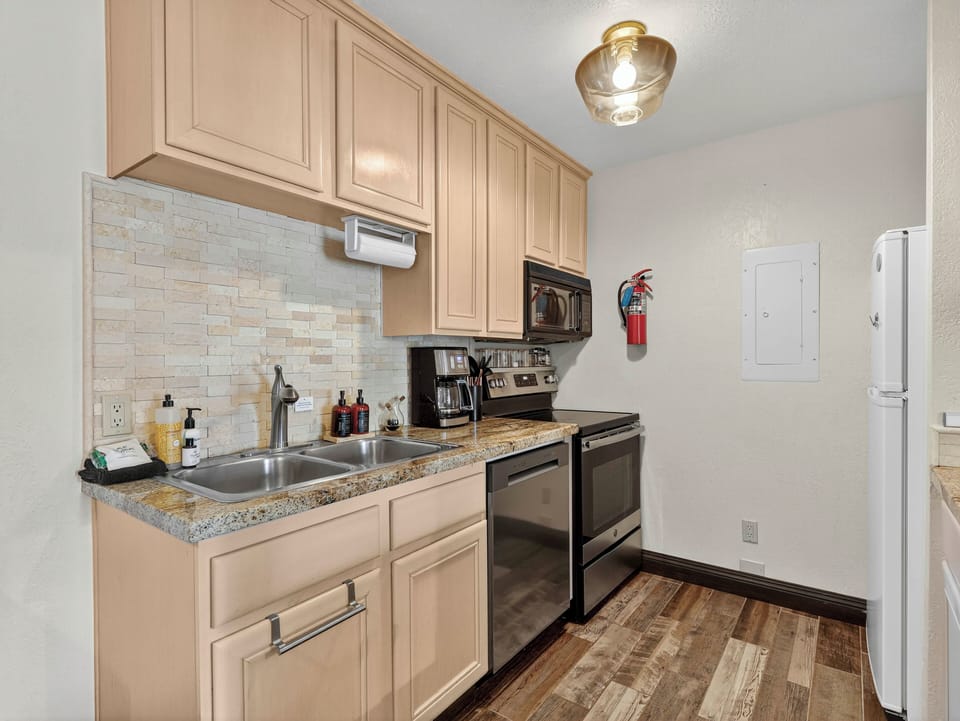 Fully equipped galley kitchen with brand-new appliances and plenty of storage, perfect for cooking during your mountain stay
