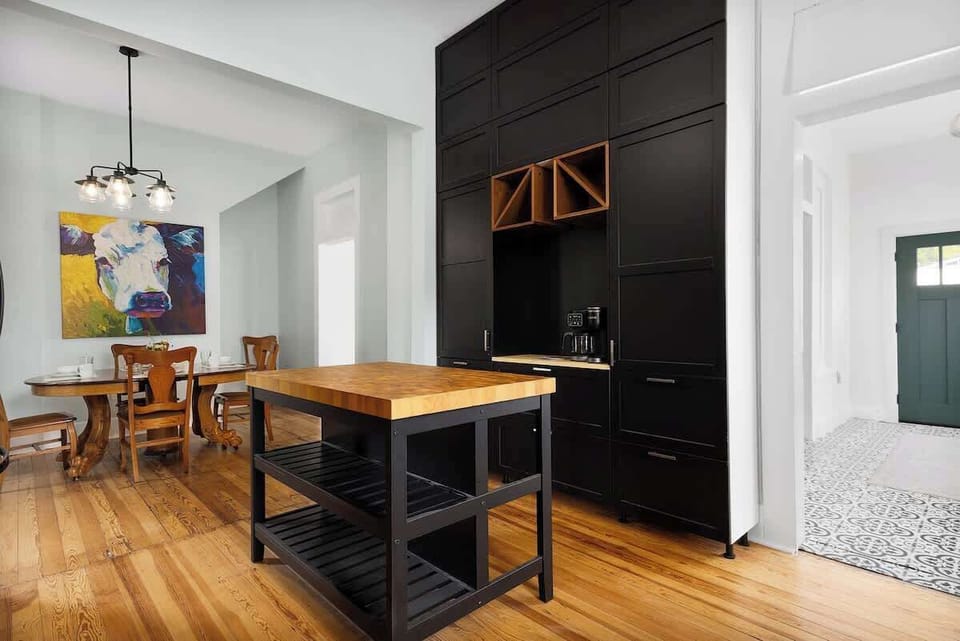 Stylish kitchen nook with black cabinetry and warm wood accents