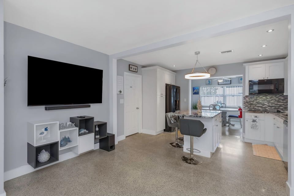 Kitchen area with island table and chairs.