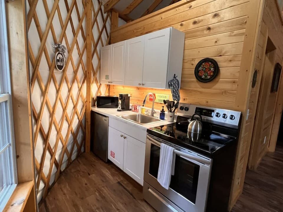 Full kitchen with mini-fridge, stove, microwave and Keurig
