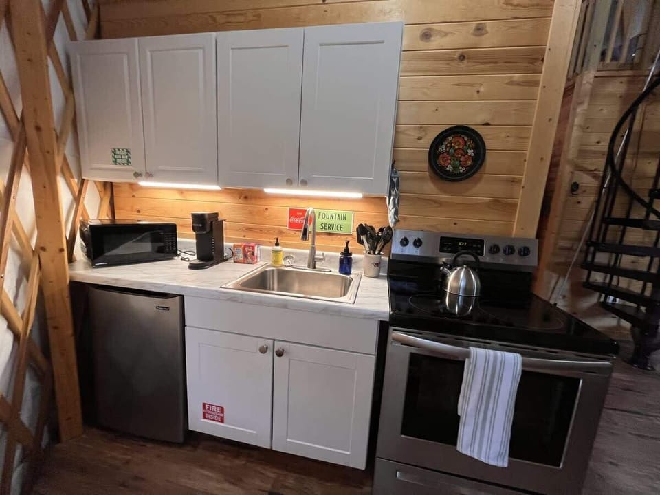 Full kitchen with mini-fridge, stove, microwave and Keurig