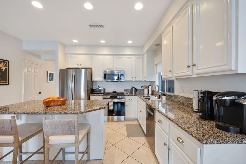Kitchen with island and two barstools.