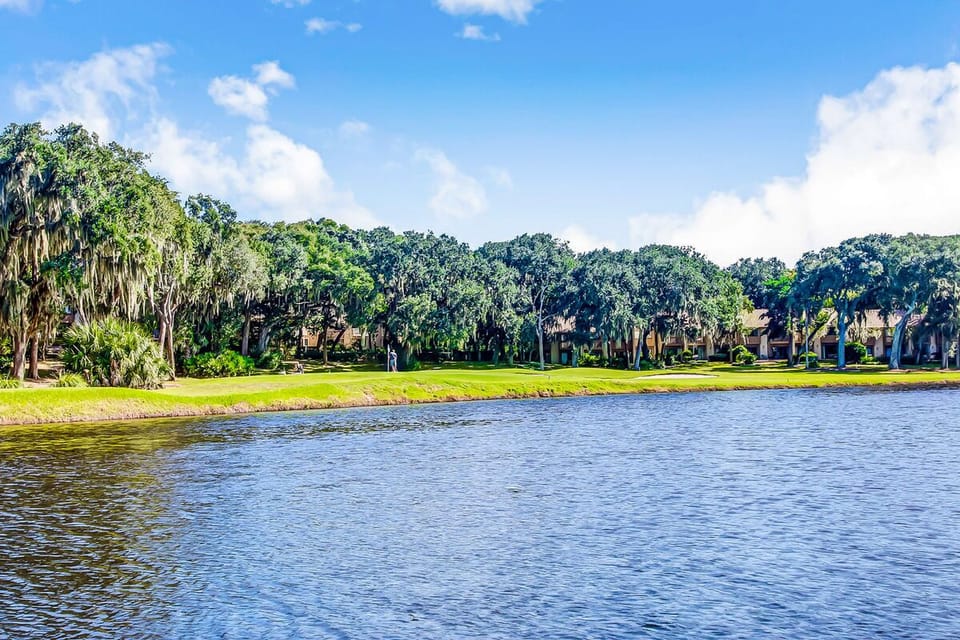 Beautiful lagoon and golf course views surrounded by lush greenery, offering a serene coastal setting.