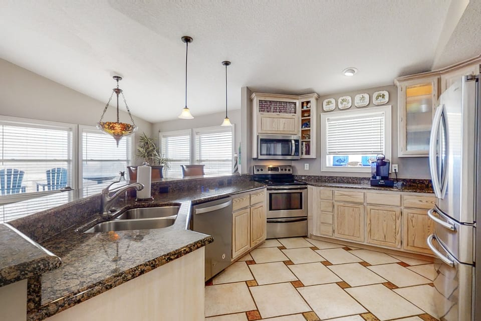 Fully equipped kitchen with modern appliances in this Amelia Island beachfront home