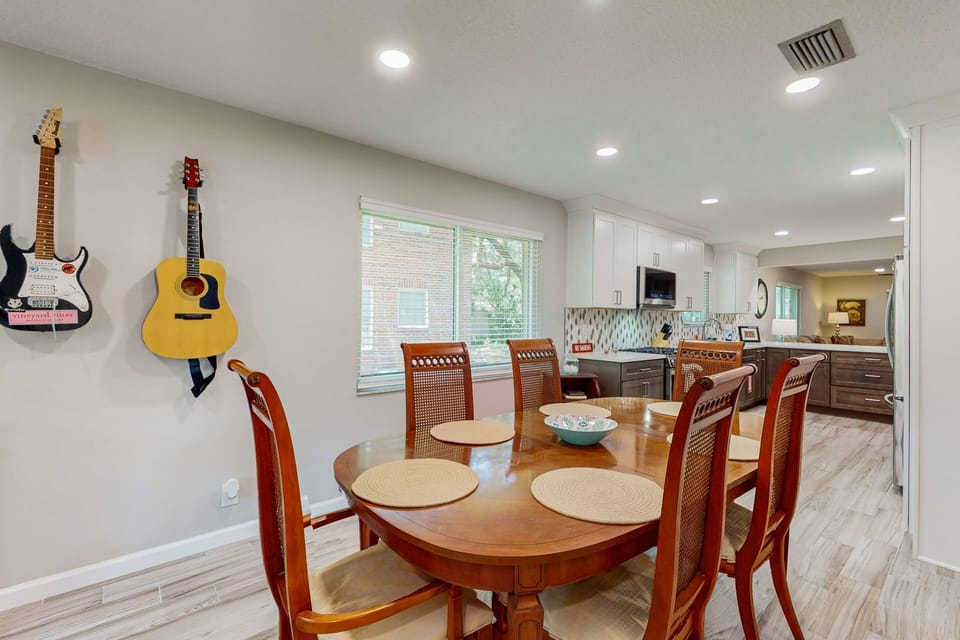 Bright kitchen and dining area with full-size appliances and a large table perfect for meals or morning coffee.