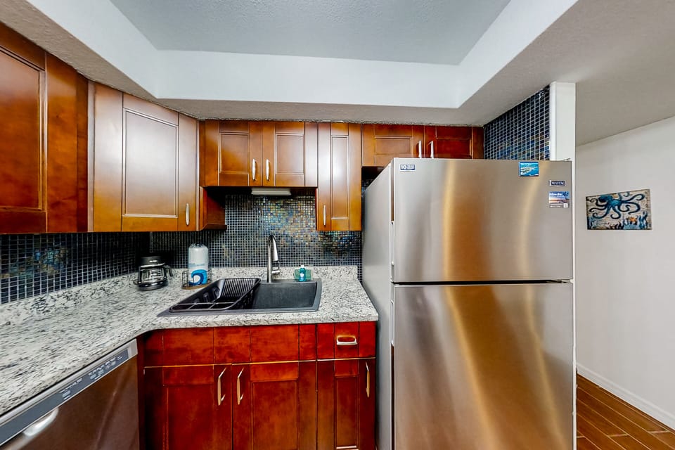 Fully equipped with stainless steel appliances, granite countertops and rich wood cabinetry. Perfect for preparing meals with ease during your stay