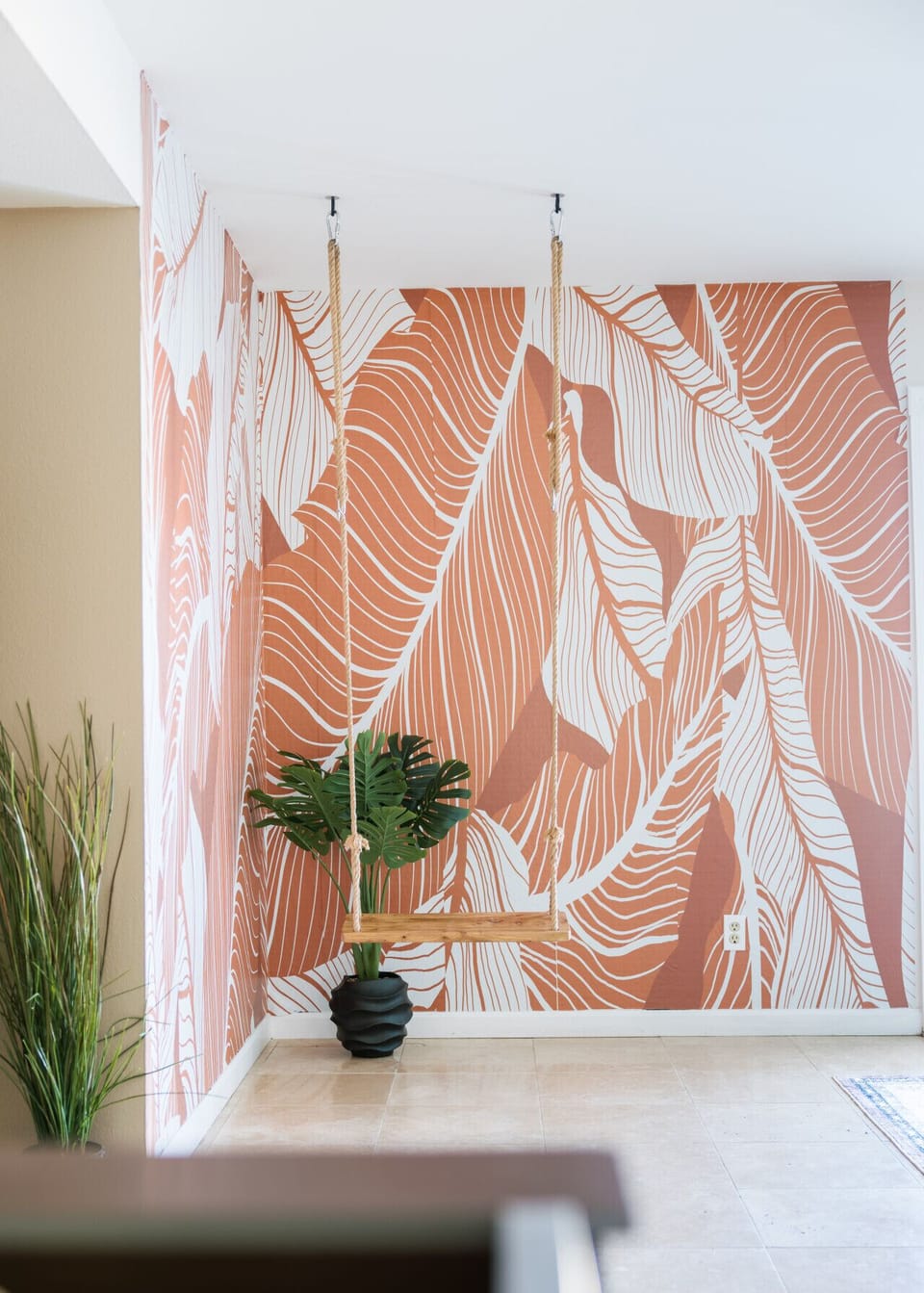 Cool wallpaper paired with a swing for a unique and memorable touch