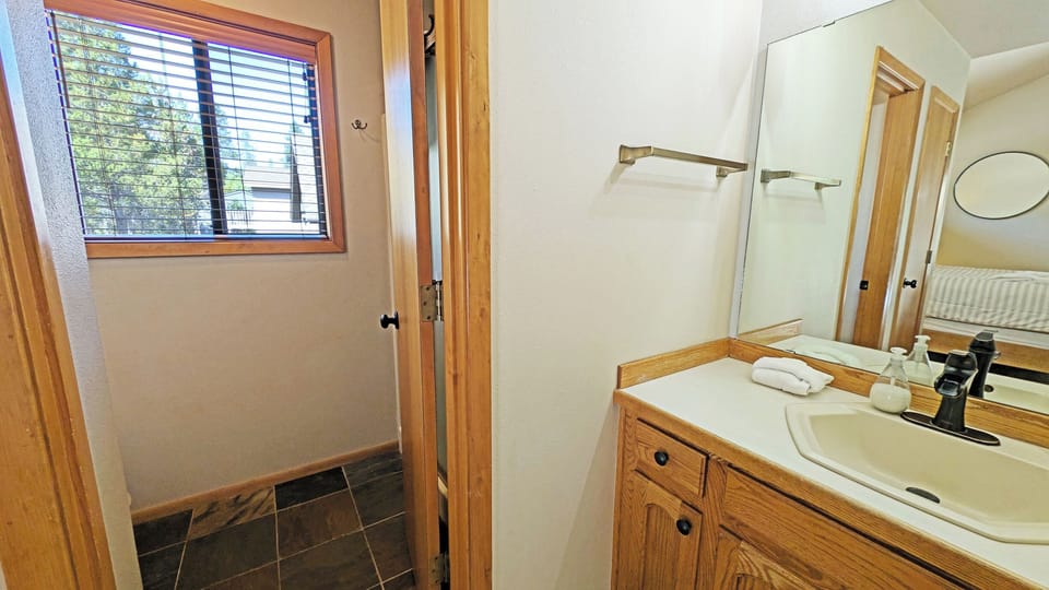 Off the Vanity is the watercloset with shower