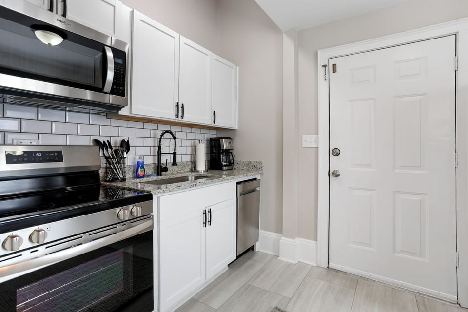 The kitchen comes fully equipped with new appliances and a coffee machine.