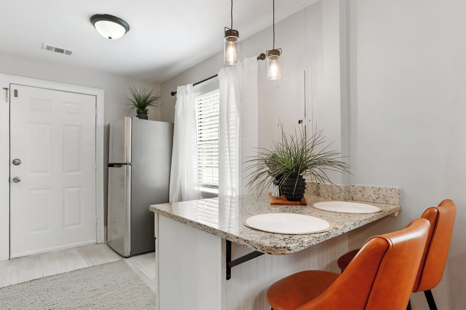 The dining area features a sleek design with vintage leather seating.