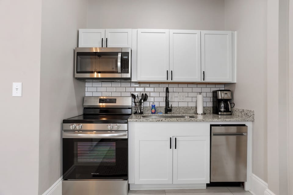 The kitchen comes fully equipped with new appliances and a coffee machine.