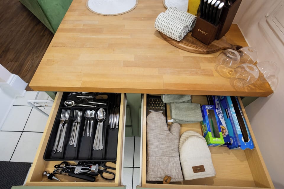 The kitchen is fully equipped with new appliances and a soft green finish.