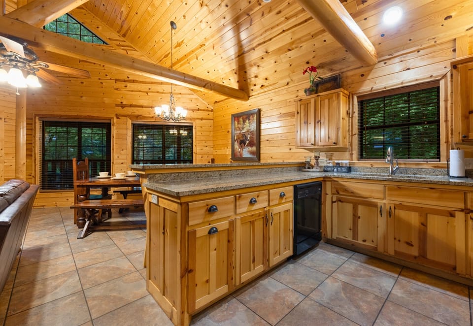 Fully stocked kitchen with modern appliances and woodsy charm.