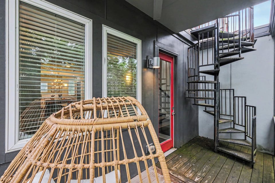 Private balcony with an outdoor chair, with a staircase leading to the rooftop deck. (2nd Floor)