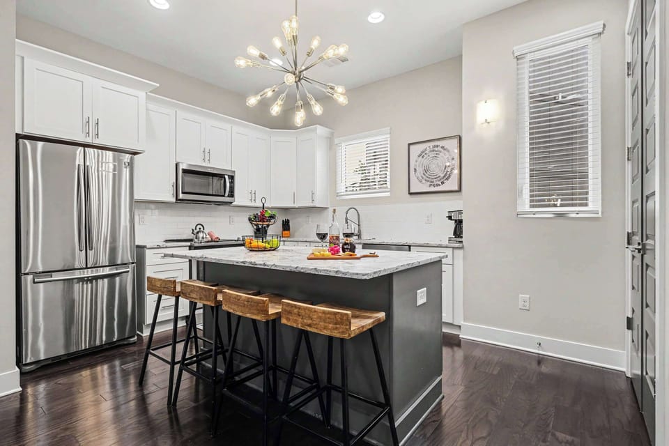 The fully equipped, modern kitchen is stocked with all the culinary essentials, including stainless-steel appliances and a wine cooler. (2nd Floor)