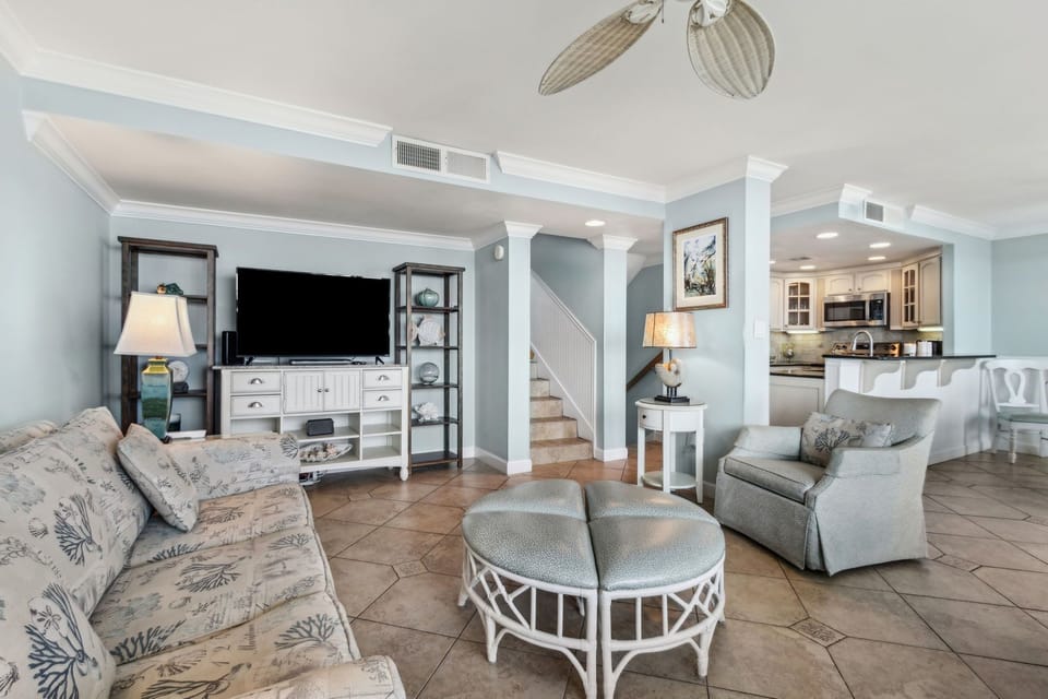 From living room, looking towards stairs leading down to bedrooms and up to entrance.