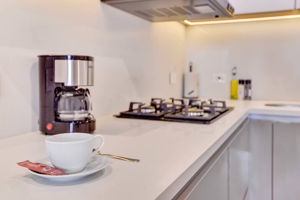 Fully equipped kitchen with coffee maker and stove