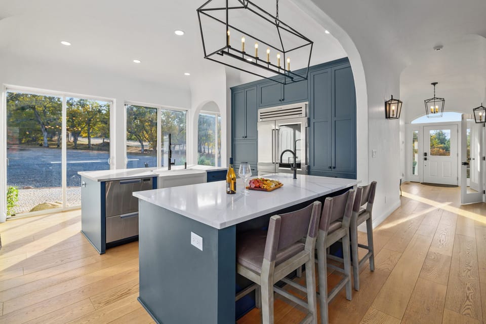 Welcome to the grand gourmet kitchen! With a dramatic wall of windows and incredible natural light, this space connects you seamlessly to the beautiful grounds. The dual islands provide ample room for both socializing and prepping a feast.
