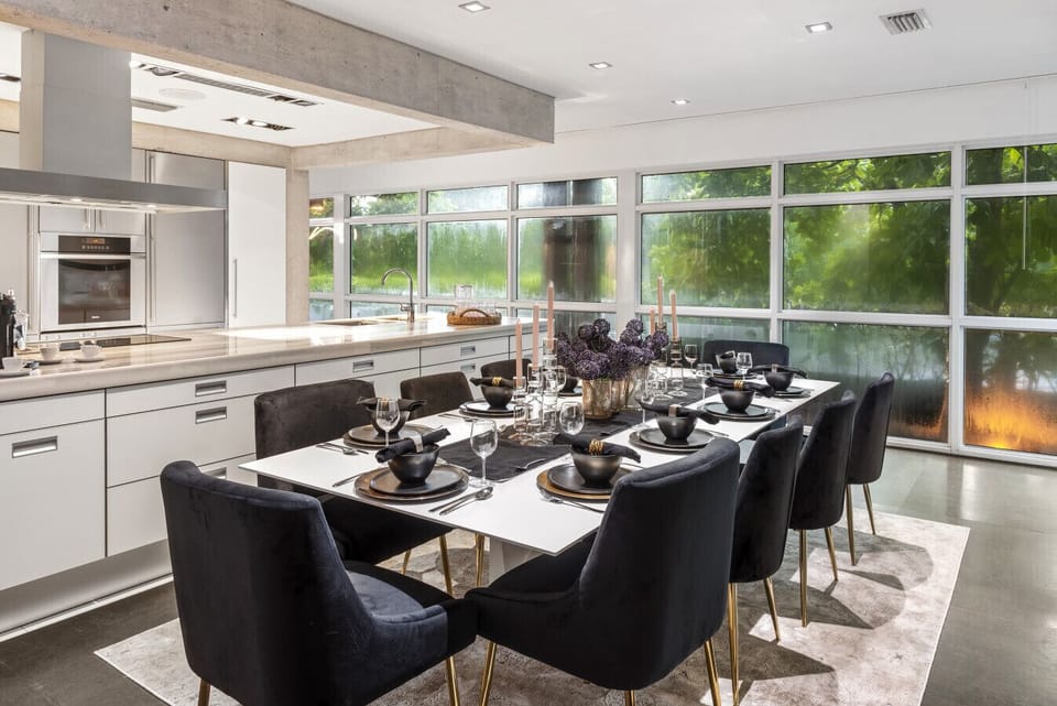 Beautiful Kitchen Dining Combination featuring Modern Black Chairs and Abundant Natural Light