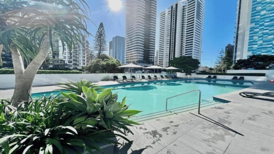 Resort-style swimming area near skyscrapers