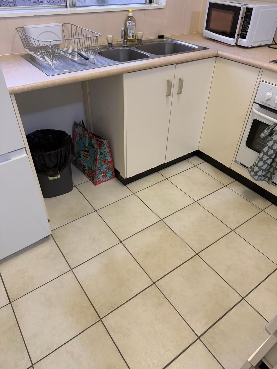 Kitchen with fridge, stove, oven,  microwave, toaster, kettle & rice cooker.