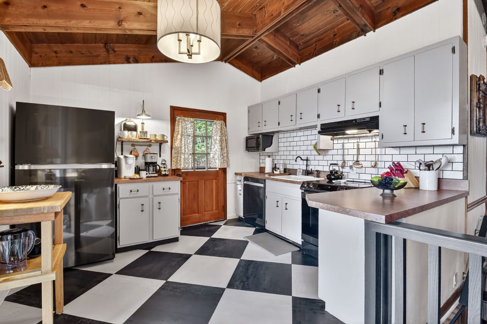 This charming farmhouse kitchen is ideal spot to cook a romantic dinner in your Georgia Mountain cabin rental