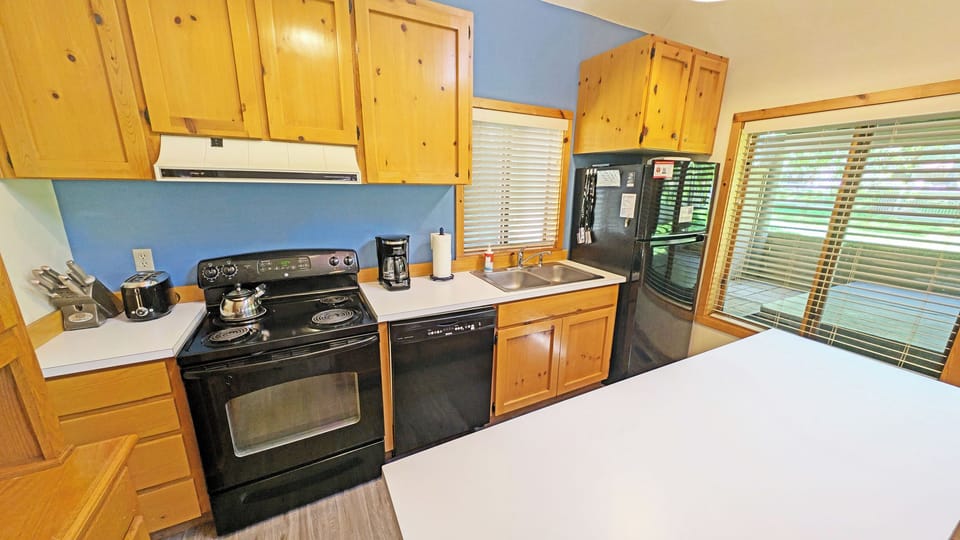 The kitchen with classic pine cabinetry, and a full set of appliances