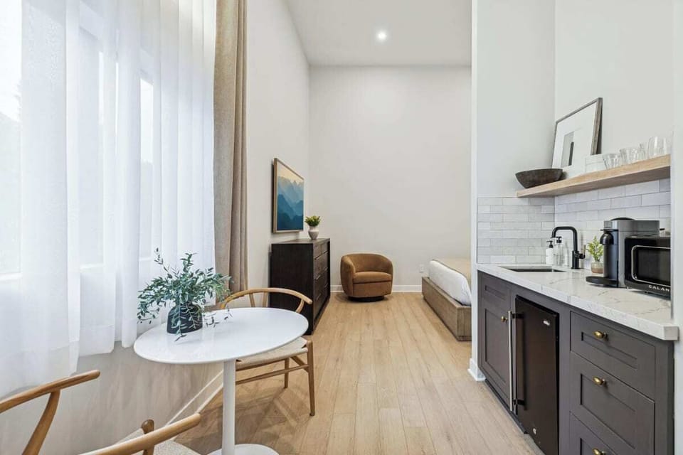 Kitchenette with mini-fridge, sink, and a Nespresso (no stove)