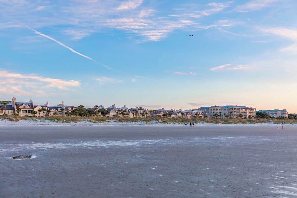 A panoramic view of the charming beach houses lining Shipyard Beach, showcasing coastal architecture and a vibrant, relaxing community atmosphere.