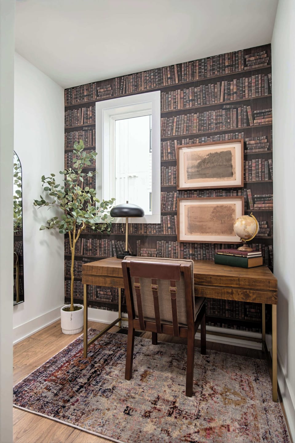 A quiet desk and bookshelf wallpaper offer a retreat when someone needs to slip away from the group energy