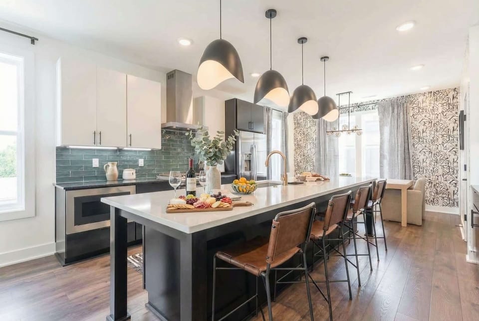 The kitchen island is your gathering spot, with bar seating that keeps everyone connected while you cook. Pendant lights overhead and a gas range set you up for group dinners in Nashville
