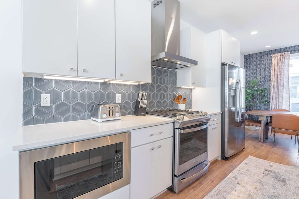 Full kitchen with stove, oven, microwave, and range hood, built for the group that's actually going to cook and gather over meals