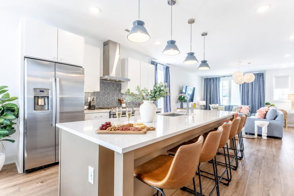 The kitchen island seats the whole crew, and the open flow to the living room means no one cooking gets left out of the conversation. Reserve your stay with Misfit Homes